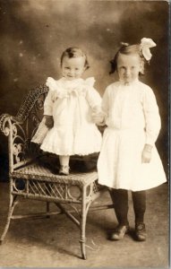 RPPC Adorable Children Sister with Hair Bow Holds on to Little One Postcard V10