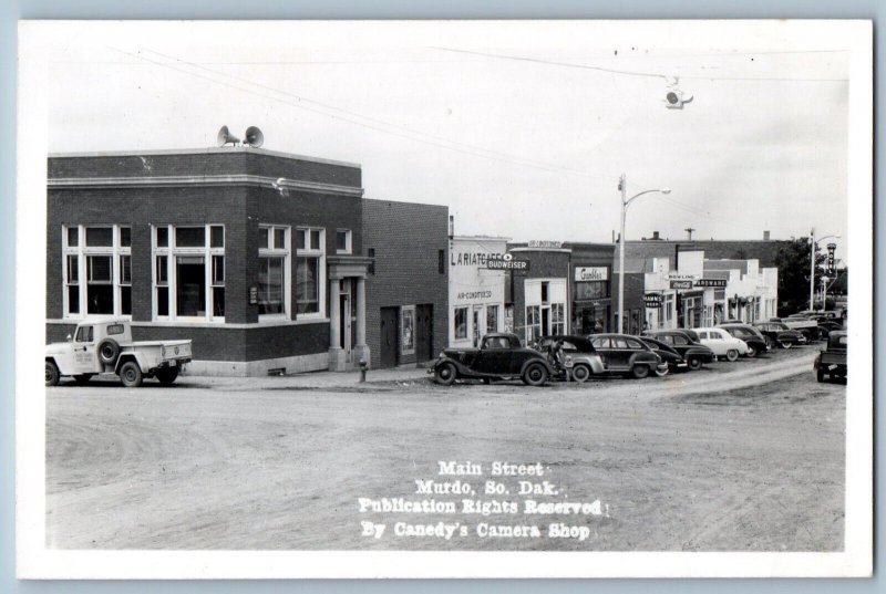 Murdo SD Postcard RPPC Photo Main Street Coca Cola Hamm's Hotel Cars Dirt Road