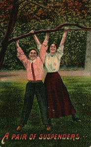 A Pair of Suspenders Boy and Girl Hanging From Tree Vintage Postcard 1911