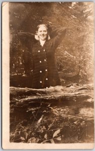 Young Woman in Long Button Down Jacket Behind Log Portrait - Vintage Postcard