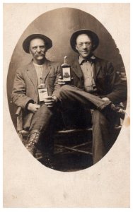 Studio Photo 2 men holding Whiskey Bottles