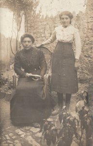 VINTAGE POSTCARD YOUNG WOMAN STANDING BESIDE HER SEATED MOTHER c. 1900-1912