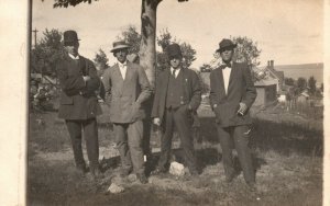 4 Men Suits Bowties Hat Standing Under Tree Photo Vintage Postcard RPPC