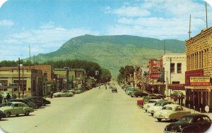 Cody WY Main Street Grocerteria Coca-Cola Sign Old Cars Postcard