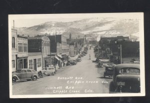 RPPC CRIPPLE CREEK COLORADO DOWNTOWN BENNETT STREET SCENE OLD CARS POSTCARD