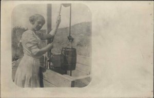 Woman at Well Pulling up Bucket c1910 Amateur Real Photo Postcard