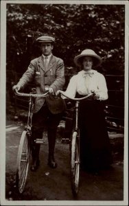 Man & Woman Bicycles - Fancy Hats Clothing c1910 Real Photo Postcard