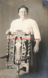 Studio Shot, RPPC, Woman Standing Behind Hand Carved Chair