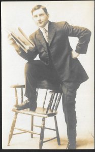 Young Man in Suit with Foot on Chair with Newspaper RPPC Unused c1910s