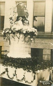 C-1910 Parade Float girls in basket Russell RPPC Photo Postcard 21-9672