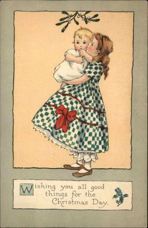 Christmas Little Girl Kisses Baby Sister Under Mistletoe c1910 Vintage Postcard