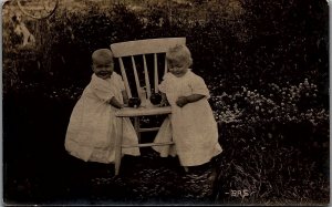c1910 CUTE SMILING BABIES WITH APPLES BESIDE CHAIR REAL PHOTO RPPC 39-145