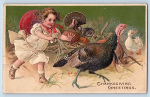 Iowa City IA Postcard Thanksgiving Greetings Little Girl Chasing Turkey Embossed