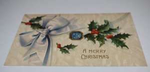 A Merry Christmas Envelope Ribbon Holly Embossed Postcard Printed in Germany