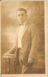 1910s RPPC Real Photo Postcard Young Man in Suit Bowtie Ornate Stand