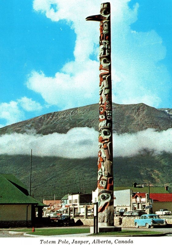 CONTINENTAL SIZE POSTCARD THE TOTEM POLE NEAR THE CANADIAN NATIONAL JASPER DEPOT