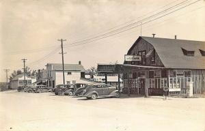 Mio MI Hardware Store Log Cabin Rooms Old Cars Street View Real Photo Postcard