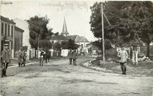 WWI era Postcard German Soldiers Stand around Lagarde France Street Scene