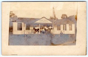 1905 ERA RPPC CAMP AROLD AMERICAN FLAG BOYS ON PORCH ANTIQUE REAL PHOTO POSTCARD