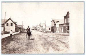 c1910's Man Riding Horse On Main Street Wagons Boy  RPPC Photo Postcard