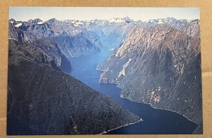 UNUSED POSTCARD - AERIAL VIEW OF THE SOUND, MILFORD SOUND, NEW ZEALAND