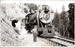 RPPC Reversed Image - Man standing next to Engine 65 outside Tunnel 31