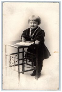 1912 Cute Little Girl Standing Desk Buffalo New York NY RPPC Photo Postcard