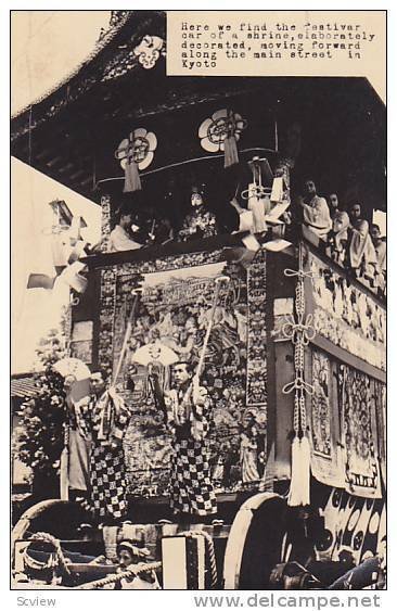 RP; Festival car of a shrine, elaborately decorated, moving forward along the...