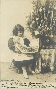 RPPC Postcard Little Girl Reads to Doll by Christmas Tree, Posted Romania 1901