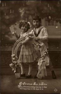 Christmas Adorable Boy and Girl Children's Clothing Real Photo c1910 Postcard