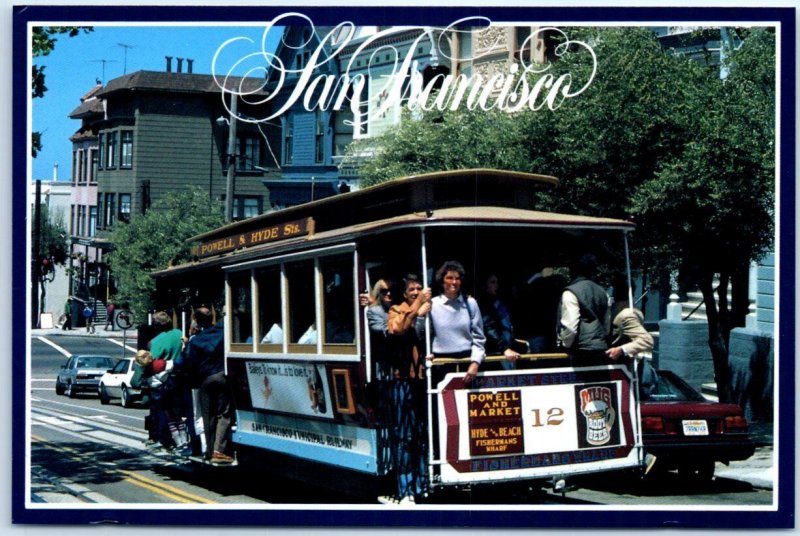 Cable cars passes a row of Victorian homes - San Francisco, California