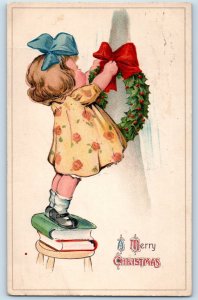 1915 Christmas Little Girl Hanging Wreath Berries Oswego NY Antique Postcard