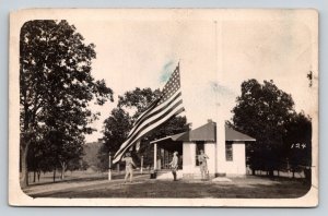 RPPC  US Army Soldiers Raising Large American Flag Reverie Retreat    Postcard