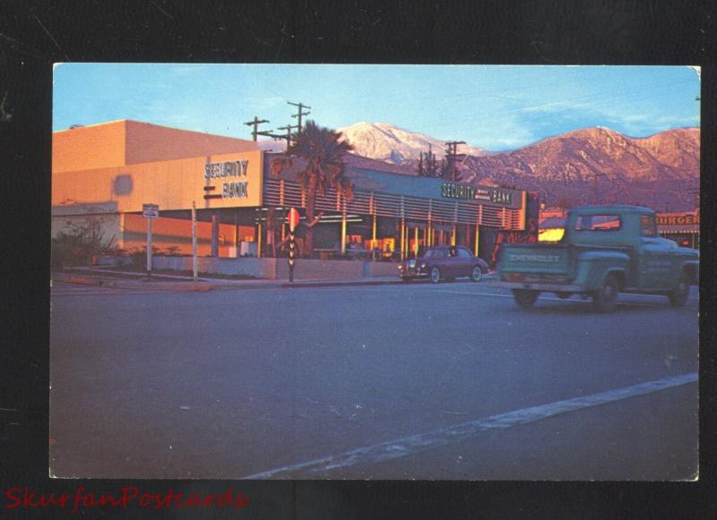 YUCAIPA CALIFORNIA DOWNTOWN STREET SCENE AT NIGHT OLD CARS VINTAGE POSTCARD