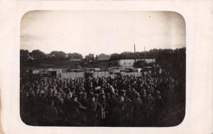 LARGE NUMBER OF GERMAN? MILITARY OUTSIDE OF FENCED AREA REAL PHOTO POSTCARD 1919