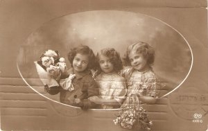 Three pretty little girls with flowers Nice old vintage Englissh postcard