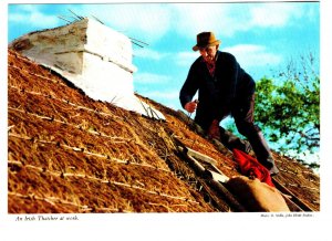 Irish Thatcher at Work on Roof, Ireland,