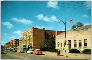 VINTAGE POSTCARD 1960s CLASSIC CARS LINED UP AT STURGIS MICHIGAN