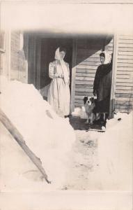 DEEP SNOW~WOMEN IN SCARVES~ON FRONT PORCH~BLACK-EYED DOG~ REAL PHOTO POSTCARD