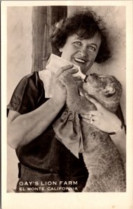 Real Photo Postcard Gay's Lion Farm in El Monte, California Woman Feeding Cub