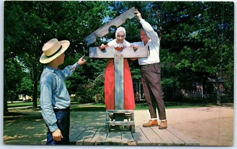 Village Hostess Being Locked into the Pillory, Old Sturbridge Village, USA 