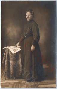 c1910s Concerned Lady Reading Newspaper? RPPC Woman Portrait Real Photo Odd A160