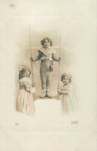 Children types and scenes lovely girls and boy on a swing photo postcard France
