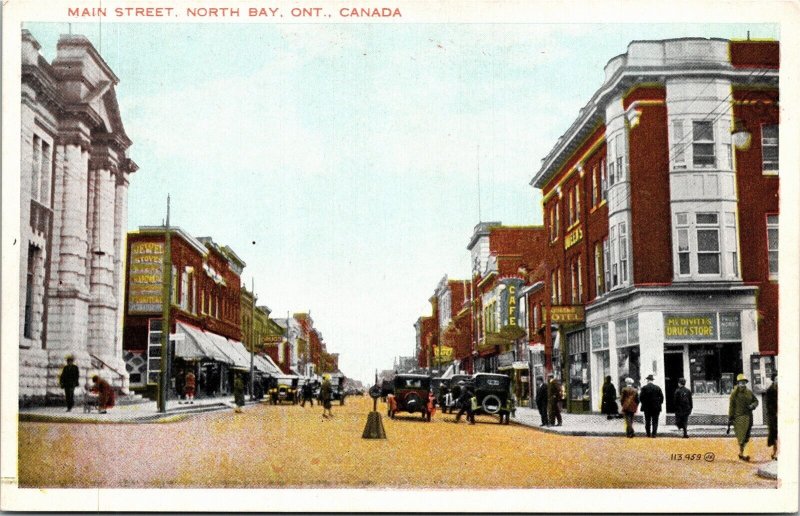 Postcard ON North Bay Main Street Drug Store Queen's Hotel Street View 1920s S97