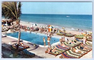 1950's SUN CITY ROOMS APARTMENTS MIAMI BEACH FL SWIMMING POOL OCEAN POSTCARD