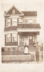 Real Photo Family Posing in Front of House