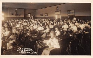 H15/ Aurora Nebraska RPPC Postcard c1910 Assembly High School Interior