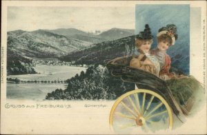 Gruss Asus Freiburg Germany i/B c1900 Postcard - Ladies Riding in Stage Border