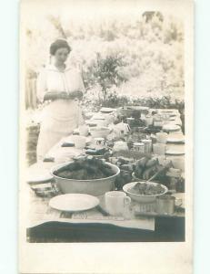 rppc Pre-1918 WOMAN SETS TABLE FOR UPCOMING FEAST DINNER AC7645