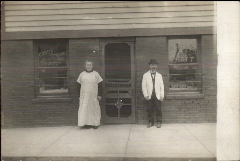 Storefront Candy Cigars Shop Keep & Wife c1910 Real Photo Postcard STORE